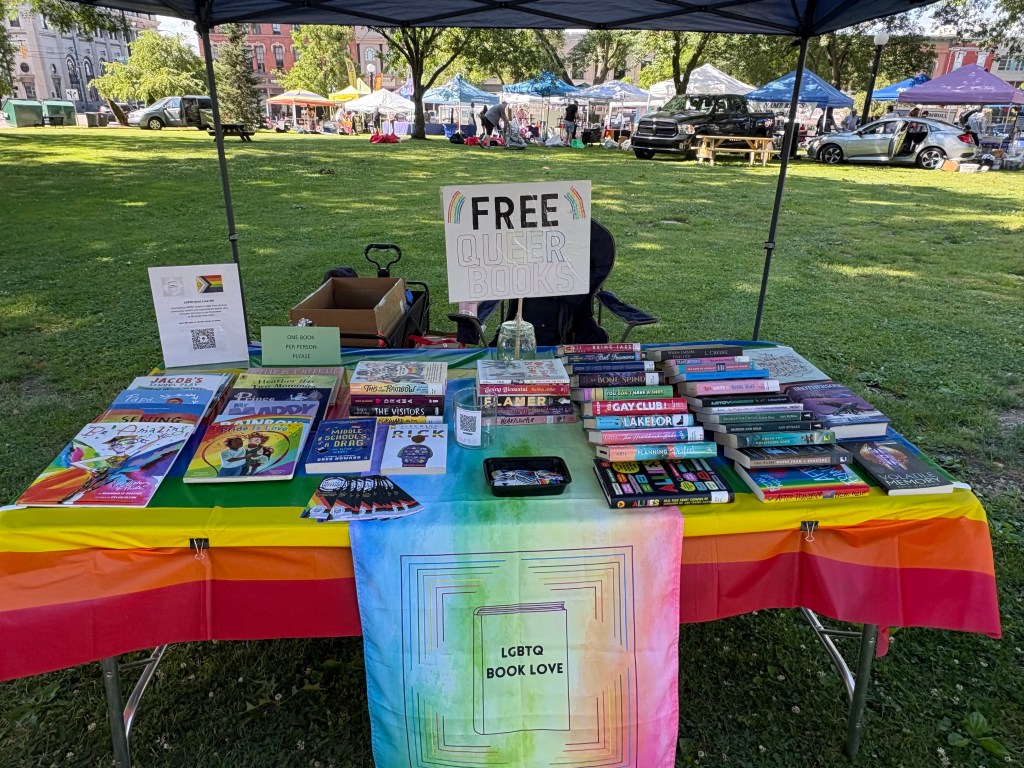 table with rainbow table cloth and an assortment of books